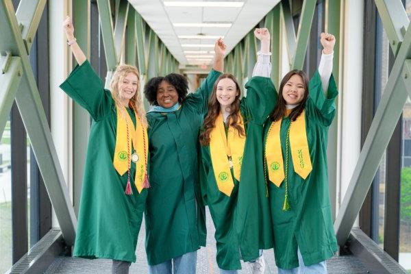 Four commencement speaker candidates smile for group photo